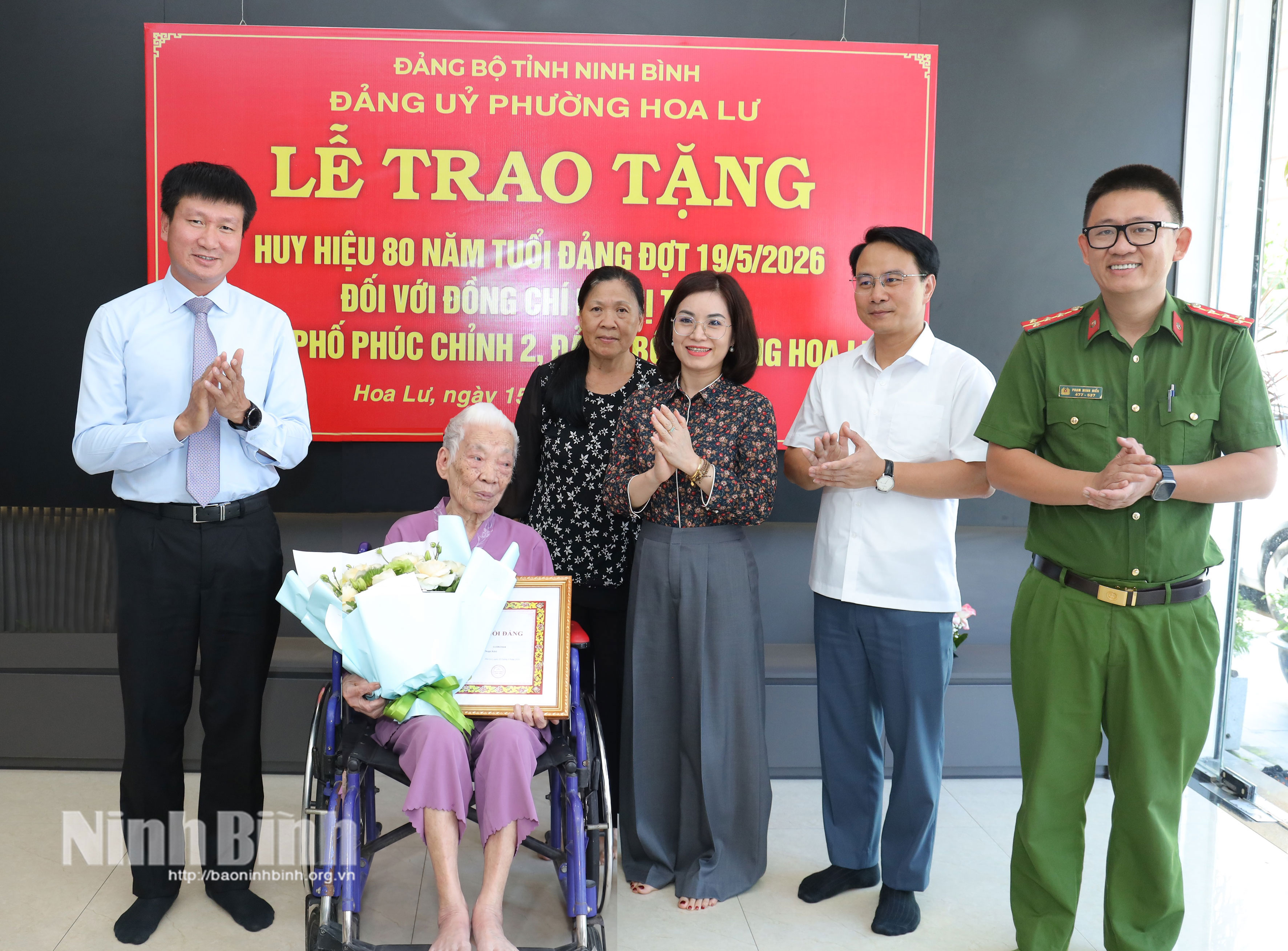 Đồng chí Trần Huy Tuấn, Ủy viên Trung ương Đảng, Bí thư Tỉnh ủy tặng hoa chúc mừng đồng chí Lê Thị Tuyết, đảng viên Chi bộ phố Phúc Chỉnh 2, Đảng bộ phường Hoa Lư.