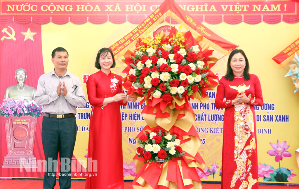 Đồng chí Đinh Thị Lụa, Phó Bí thư Thường trực Tỉnh uỷ tặng hoa chúc mừng Ngày hội Đại đoàn kết toàn dân tộc tại Tổ dân phố số 1, phường Lý Thường Kiệt.