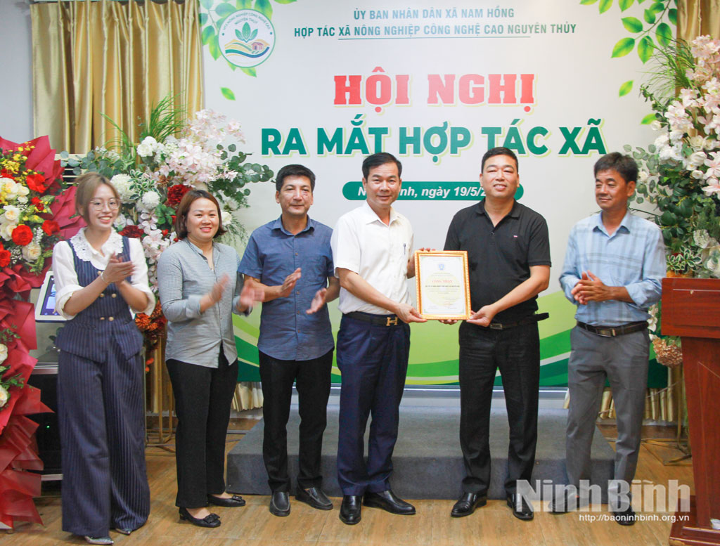 Lãnh đạo Liên minh HTX tỉnh trao giấy chứng nhận thành viên cho HTX nông nghiệp công nghệ cao xã Nam Hồng.