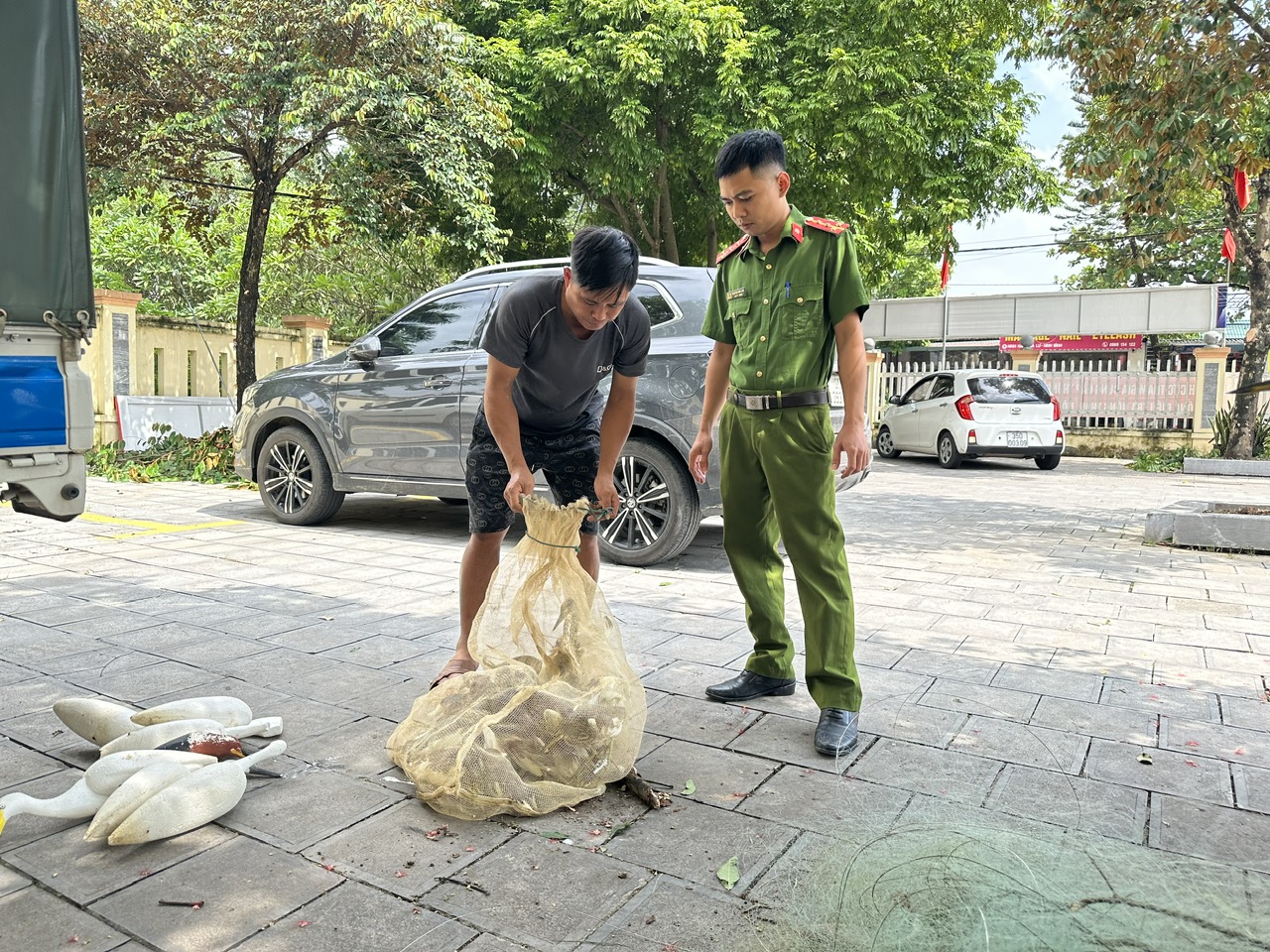 Đối tượng bẫy, bắt chim hoang dã cùng tang vật được đưa về cơ quan Công an để xử lý.